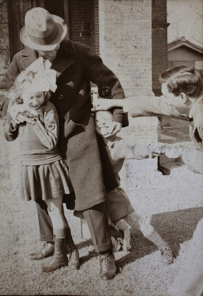 John Piry and Charles Hutchinson playing with the neighbouring children, 35 Tongshan Road, Hongkou, Shanghai