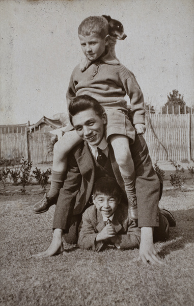 A living pyramid made by Fred and Bill Hutchinson, the neighbouring boy, and a dog, 35 Tongshan Road, Hongkou, Shanghai