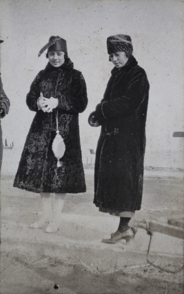 Two young women wearing fashionable winter coats and hats, Wusong, February 1920