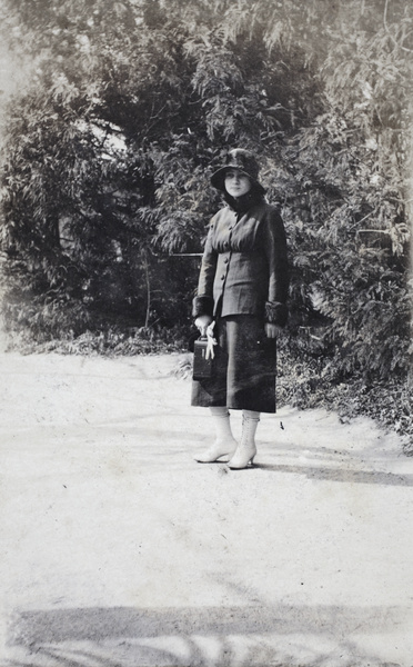 Young woman carrying a camera in Jessfield Park, Shanghai