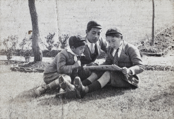 Fred, Harry and Dick Hutchinson reading a Sunday comic strip, 35 Tongshan Road, Hongkou, Shanghai