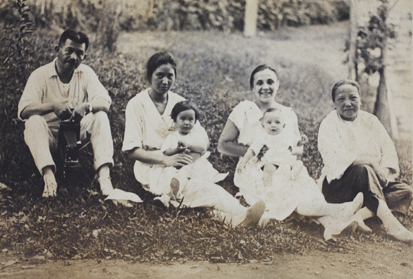 Unidentified man holding a camera, with Sarah, Bea, Margie and Sonny Hutchinson, and amah, Moganshan