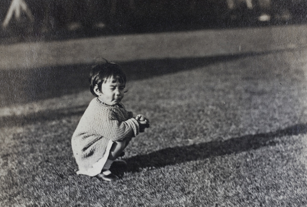 Bea Hutchinson eating a peach in the garden, 35 Tongshan Road, Hongkou, Shanghai