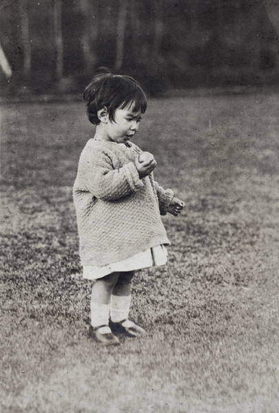 Bea Hutchinson eating a peach in the garden, 35 Tongshan Road, Hongkou, Shanghai