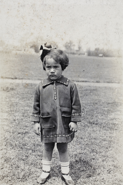 An unidentified girl wearing a homemade dress, standing in a park, Shanghai