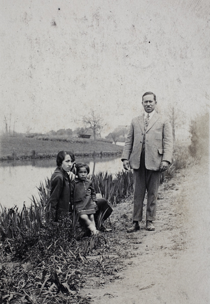 Unidentified family on a path beside a river, Shanghai