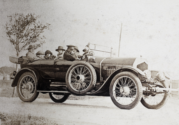 Charles and Margie Hutchinson with the Hansen family in the back seats of a Crossley automobile, and a uniformed driver, Huangjao Road, Shanghai