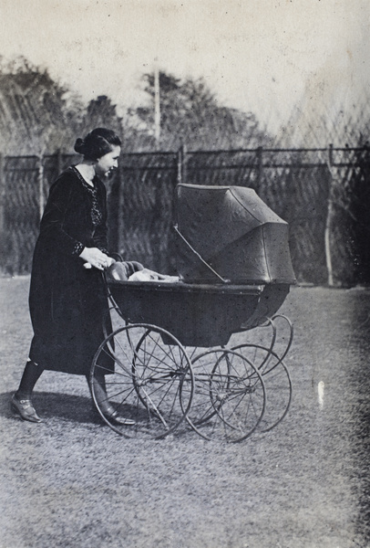 Sarah Hutchinson pushing a baby pram in the garden, 35 Tongshan Road, Hongkou, Shanghai