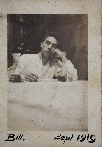 Bill Hutchinson sitting at a table in the dining room, 35 Tongshan Road, Hongkou, Shanghai