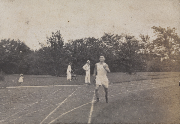 Spectators and runner at a 4th of July sports day, Shanghai, 1922