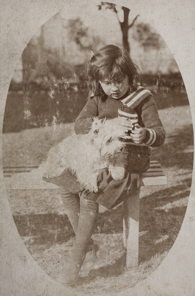 Unidentified girl sitting with a dog in the garden, 35 Tongshan Road, Hongkou, Shanghai