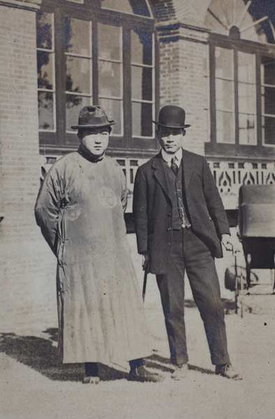 William Hutchinson wearing a suit and bowler hat with an unidentified man wearing a silk robe and fedora hat, 35 Tongshan Road, Hongkou, Shanghai