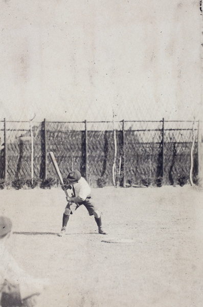 Fred Hutchinson playing with a baseball bat in the garden, 35 Tongshan Road, Hongkou, Shanghai