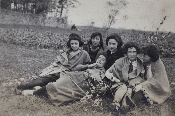 Maggie Hutchinson and friends, with branches of winter flowering almond, sitting in a field, Kunshan 