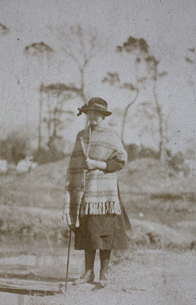 Sarah Hutchinson wearing a blanket shawl, standing by a wooden plank bridge near Tongshan Road, Hongkou, Shanghai  