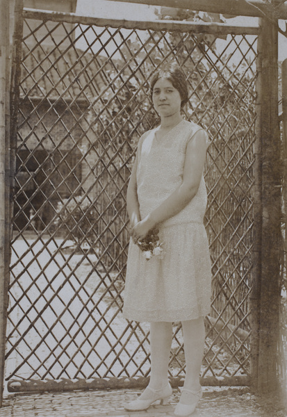 Sarah Hutchinson wearing a drop waist dress and holding a small bouquet of flowers, 35 Tongshan Road, Hongkou, Shanghai