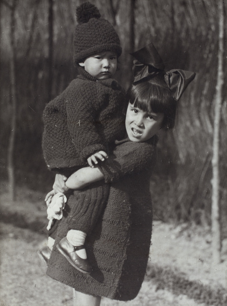 Miss Oliveira holding Bea Hutchinson in the garden, 35 Tongshan Road, Hongkou, Shanghai 