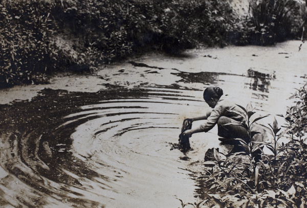 Woman washing laundry in the creek near Tongshan Road, Hongkou, Shanghai