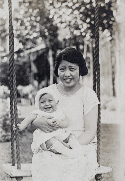 Georgina Kirby sitting on the garden swing holding her baby daughter, 35 Tongshan Road, Hongkou, Shanghai