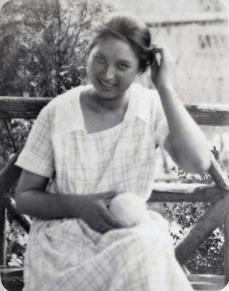 Sarah Hutchinson sitting in the wooden summerhouse holding a ball of knitting wool, 35 Tongshan Road, Hongkou, Shanghai