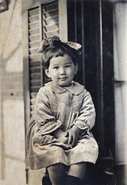 Bea Hutchinson wearing a hair bow and a hand-smocked dress, 35 Tongshan Road, Hongkou, Shanghai