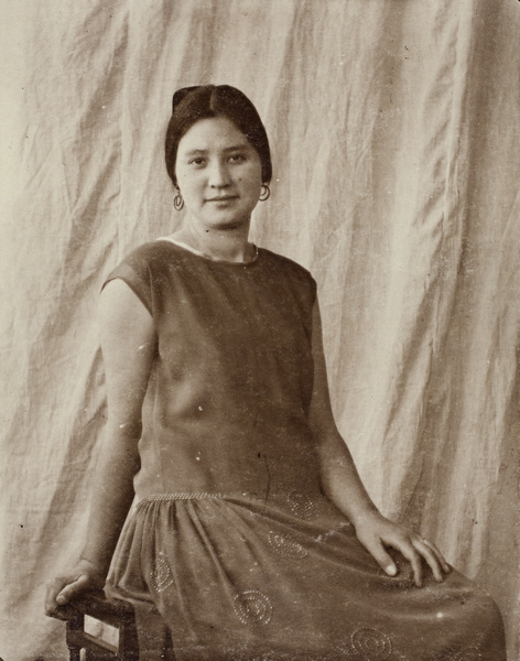 Sarah Hutchinson wearing hoop earrings and a dress decorated with hand-sewn beading, Hongkou, Shanghai