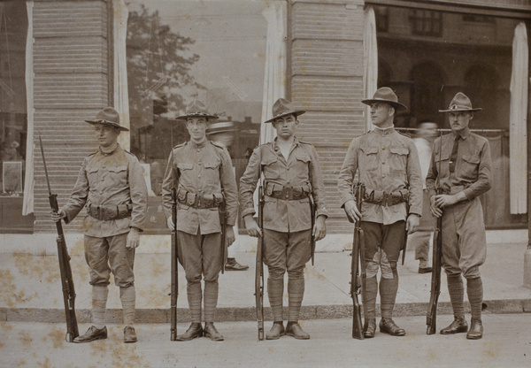 American Company Shanghai Volunteer Corps members on duty with rifles on Suzhou Road, Shanghai, 1925