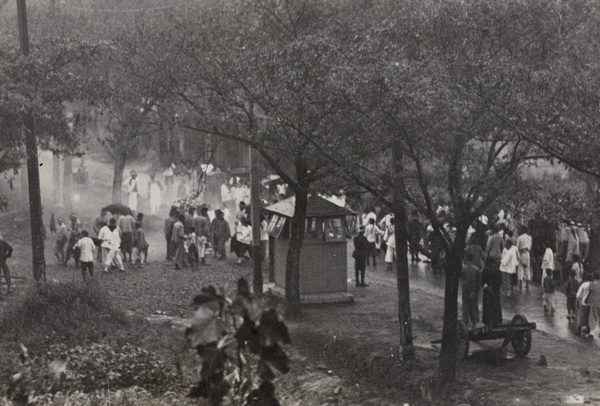 Crowd of people gathering in the rain, near 35 Tongshan Road, Hongkou, Shanghai