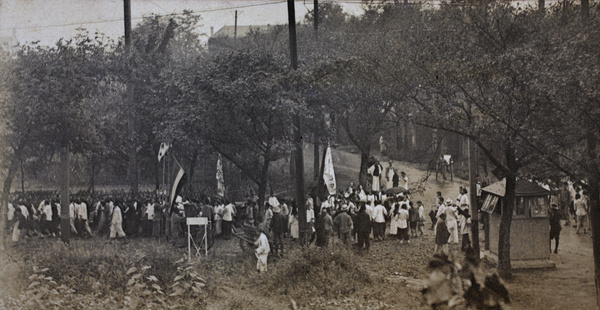 Crowd of people with banners gathering to march at the corner of Tongshan Road and Dalny Road, Hongkou, Shanghai