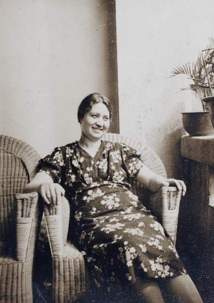 Sarah Hutchinson sitting on the veranda of the apartment block 166-188 Prince Edward Road, Kowloon, Hong Kong