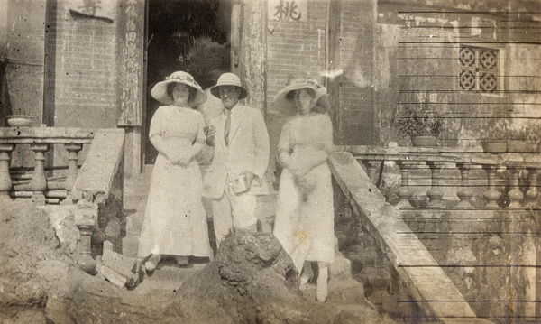 European tourists on steps of old Chinese building