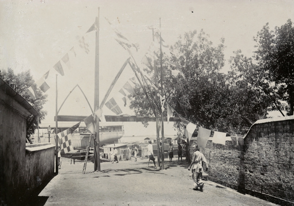 Flags in street by Bund, Kiukiang