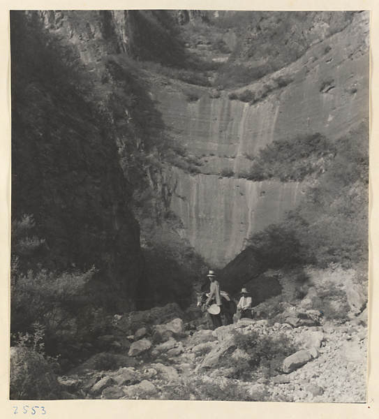 Guides and donkey in narrow, dry riverbed of the Liuli River surrounded by steep terrain, formerly the site of waterfalls