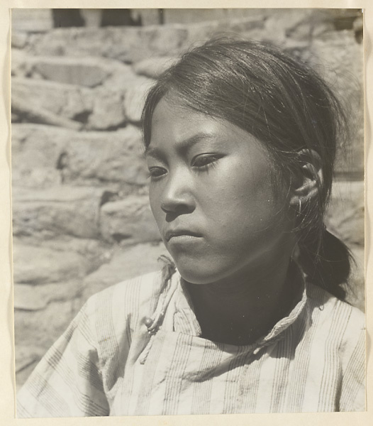 Woman wearing earrings in Lo-pu-ch'iao Village [sic] in the Jumahe Valley