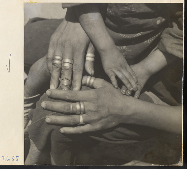 Woman wearing jewelry holding a child in the Lost Tribe country