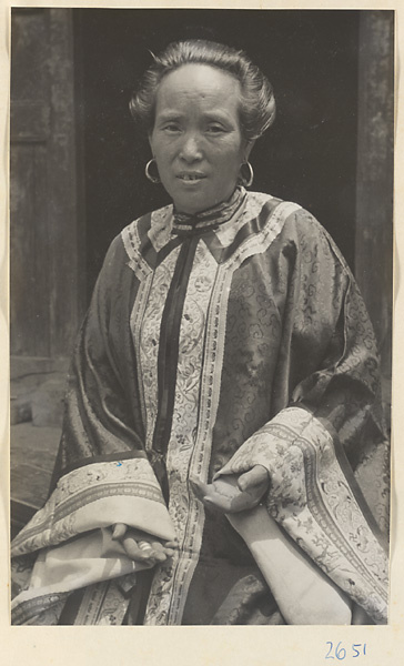 Woman wearing elaborate heirloom robe and earrings in Sang-yuan Village [sic] in the Lost Tribe country