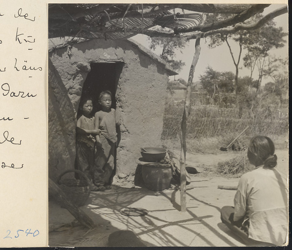 Woman and children outside a house on the way to the Lost Tribe country