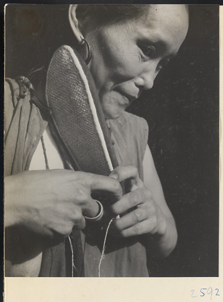 Woman sewing shoes in the Lost Tribe country