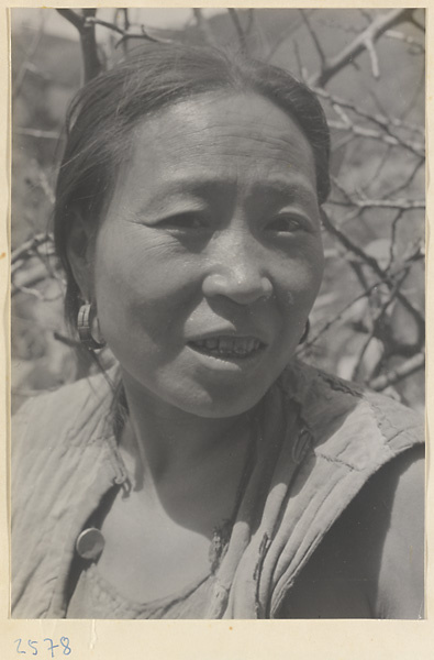 Woman wearing earrings in Tio-liu-po Village [sic]