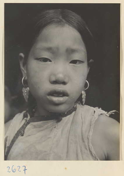 Woman wearing earrings with floral motif in the Lost Tribe country