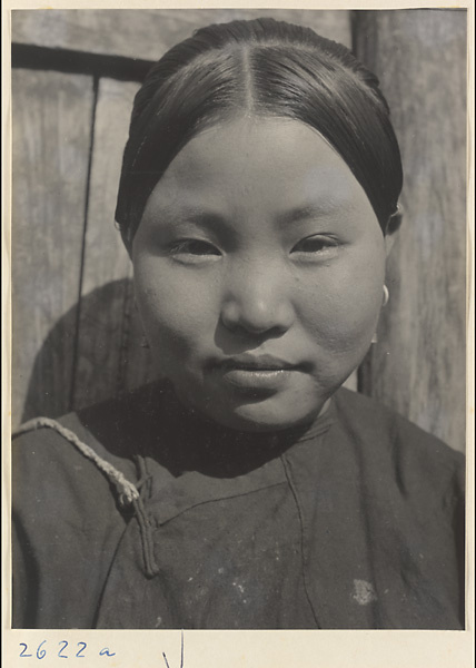 Woman with teapot hairstyle and earrings in the Lost Tribe country