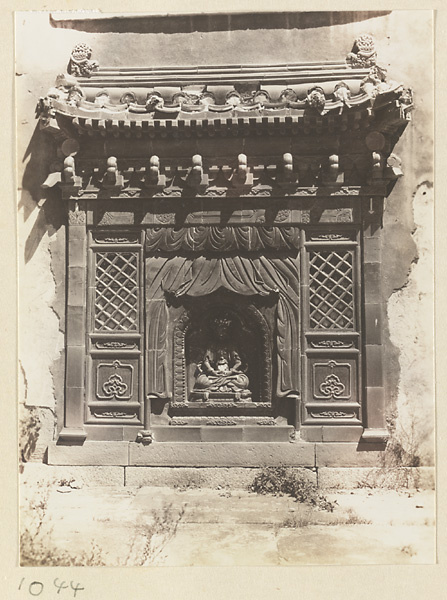 Detail of the south facade of Da hong tai at Pu tuo zong cheng miao showing showing a Buddha niche with glazed-tile relief work