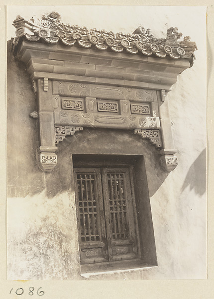 Facade detail of Da hong tai at Xu mi fu shou miao showing a window with glazed-tile relief work