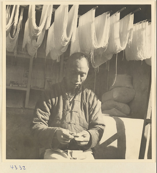 Noodle vendor drying noodles on racks in Baoding