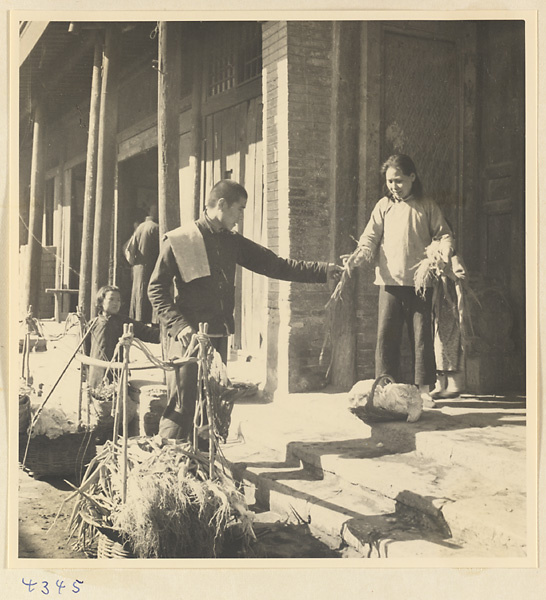 Woman buying produce from a street vendor in Baoding