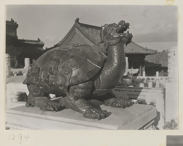 Bronze tortoise-shaped incense burner on south terrace of Tai he dian with roof of Zhong zuo men in background
