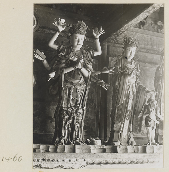 Two statues of Bodhisattvas, one with multiple arms, and an attendant at Da Fo si