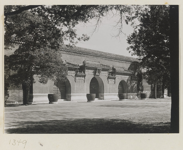Triple-arched gate and four water vats in the Forbidden City