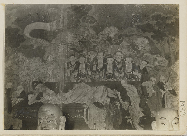 Heads of Luohans and mural detail showing reclining Buddha at Qian men temple or Guan di miao