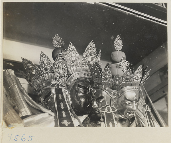 Detail showing heads of crowned multi-headed Lamaist deities at Yong he gong